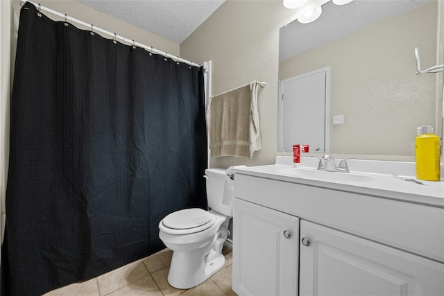 bathroom featuring tile patterned floors, vanity, toilet, and a textured ceiling