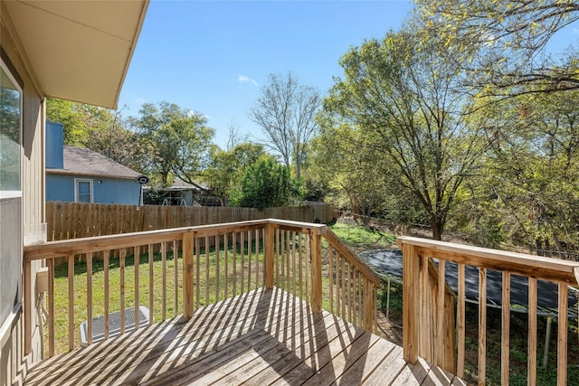 wooden terrace featuring a yard