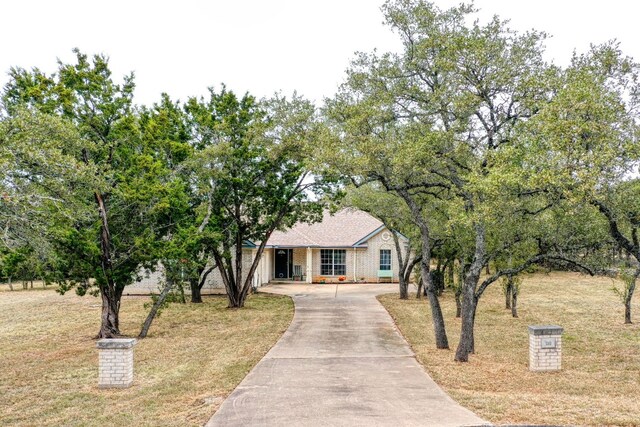 view of front of house featuring driveway and a front yard