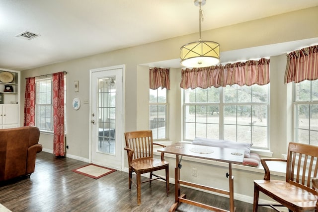 sitting room with visible vents, plenty of natural light, baseboards, and wood finished floors