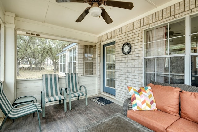 sunroom featuring a ceiling fan