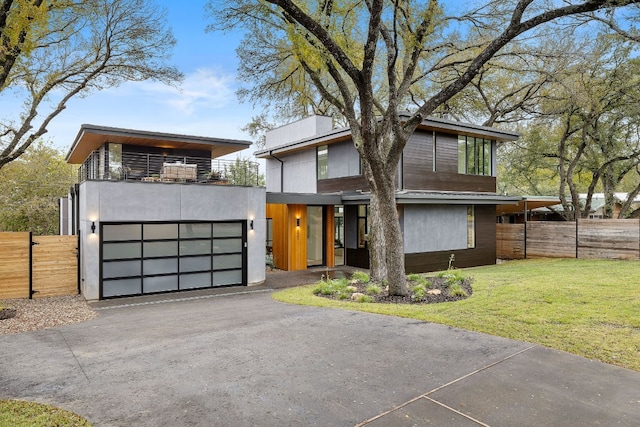 modern home with a balcony and a front lawn