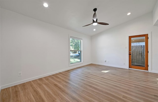 empty room with ceiling fan, light hardwood / wood-style flooring, and lofted ceiling