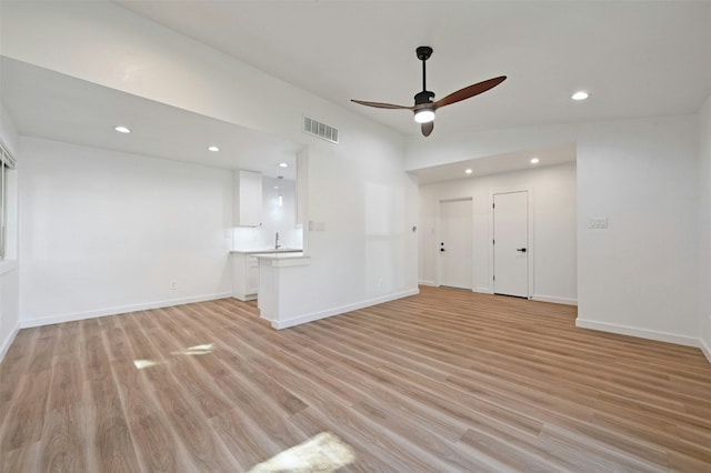 unfurnished living room featuring light wood-type flooring and ceiling fan