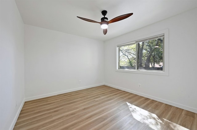 spare room featuring light wood-type flooring and ceiling fan