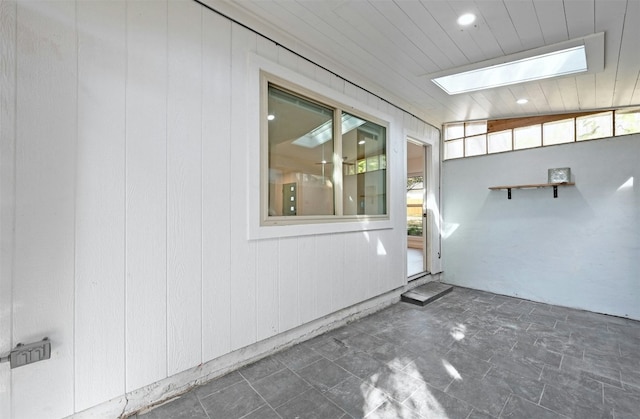 interior space featuring wooden walls and vaulted ceiling