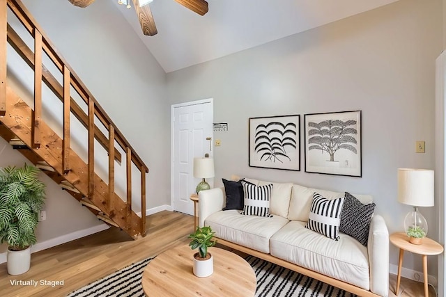 living room with hardwood / wood-style flooring, high vaulted ceiling, and ceiling fan