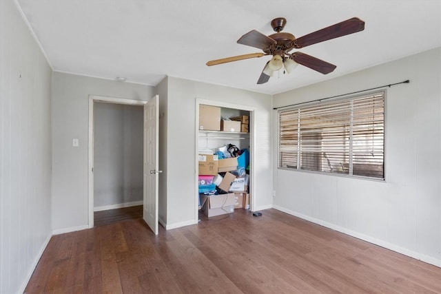 unfurnished bedroom with hardwood / wood-style flooring, ceiling fan, and a closet