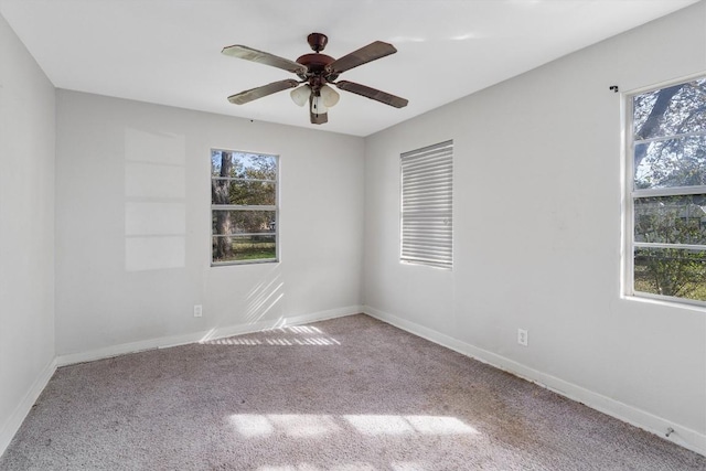 carpeted spare room with ceiling fan