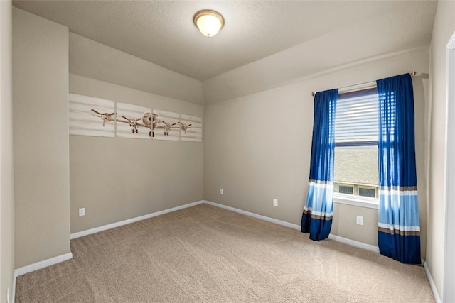 carpeted spare room with a textured ceiling