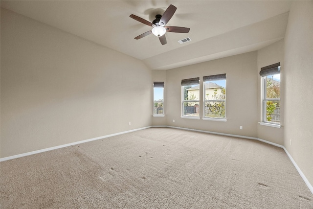 empty room with ceiling fan, light colored carpet, and lofted ceiling