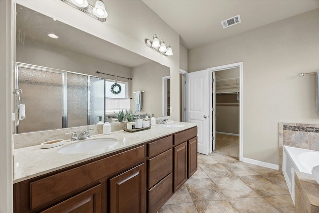 bathroom featuring separate shower and tub and vanity