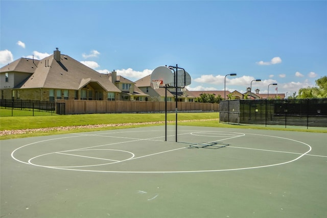 view of basketball court featuring a yard