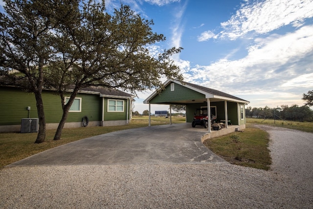 exterior space with a carport, central air condition unit, and a front yard