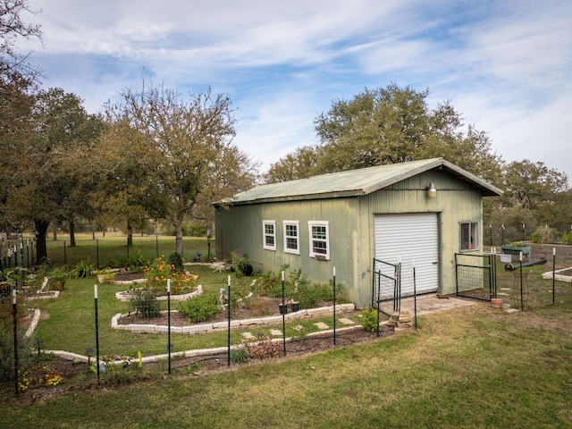 view of outbuilding with a yard and a garage