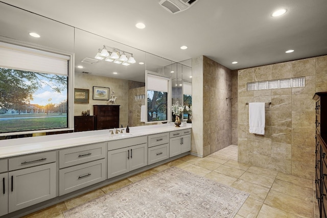 bathroom featuring vanity, tile walls, and walk in shower