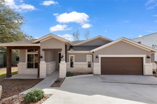 20701 Deep Crk, Lago Vista, TX 78645 - view of front of home featuring stucco siding, a garage, driveway, roof with shingles, and stone siding