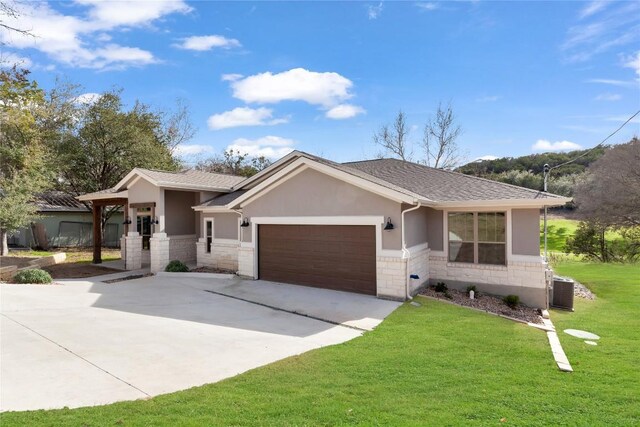 20701 Deep Crk, Lago Vista, TX 78645 - view of front of property with stone siding, stucco siding, an attached garage, and concrete driveway