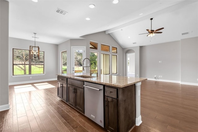 kitchen with vaulted ceiling with beams, dark hardwood / wood-style floors, light stone counters, and sink