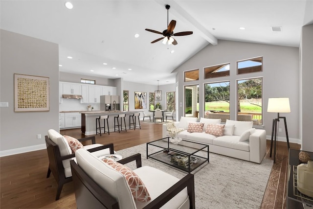 20701 Deep Crk, Lago Vista, TX 78645 - living area featuring ceiling fan, baseboards, wood finished floors, beam ceiling, and high vaulted ceiling
