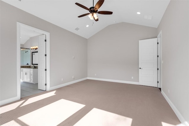 unfurnished bedroom featuring connected bathroom, light carpet, ceiling fan with notable chandelier, and vaulted ceiling