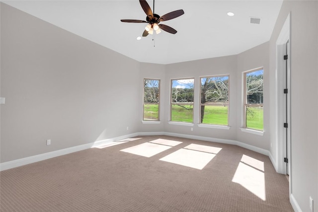 empty room featuring light carpet and ceiling fan