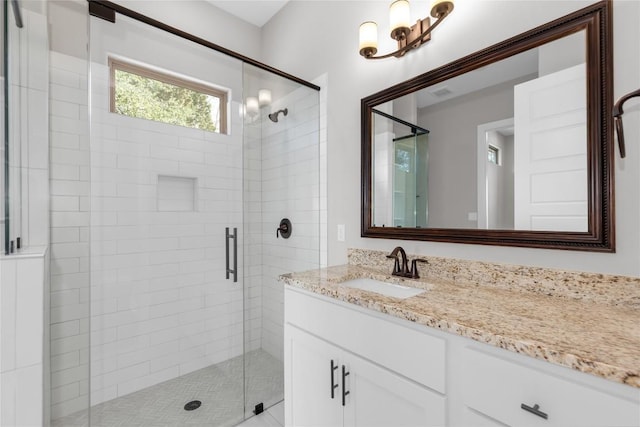 20701 Deep Crk, Lago Vista, TX 78645 - full bath featuring a stall shower, vanity, and a chandelier