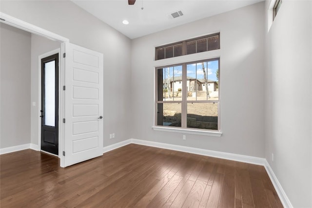 unfurnished room featuring dark hardwood / wood-style flooring and ceiling fan