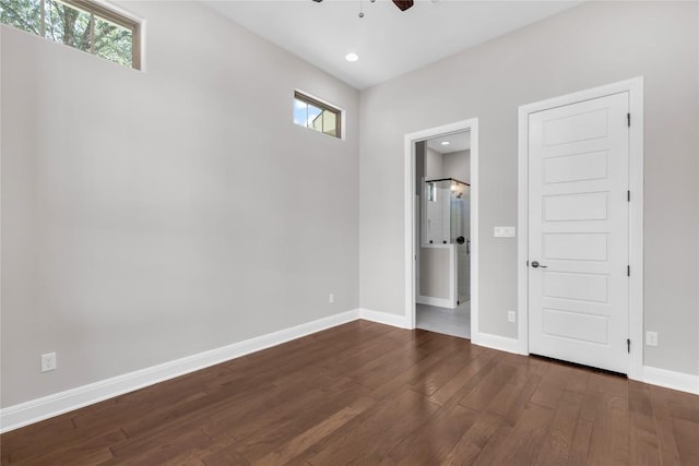 unfurnished room featuring ceiling fan and dark hardwood / wood-style floors