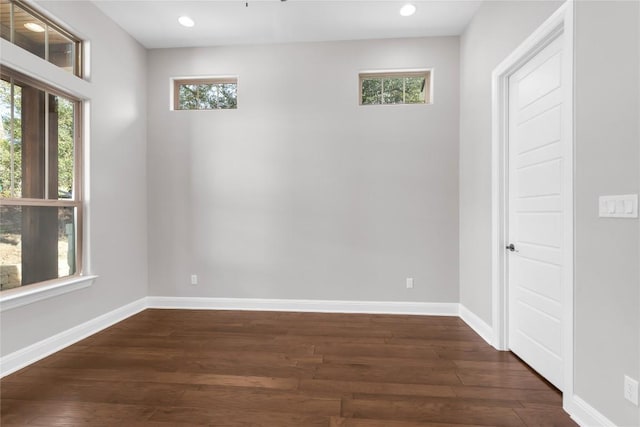 unfurnished room with dark hardwood / wood-style flooring