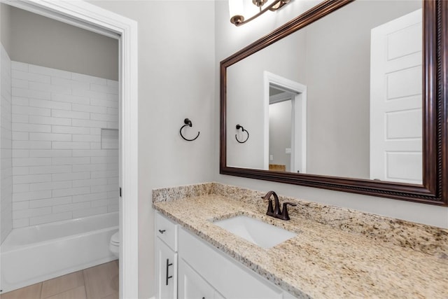 full bathroom with tile patterned floors, vanity, toilet, and tiled shower / bath combo