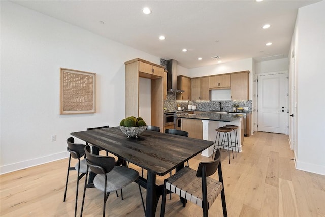 dining room with sink and light hardwood / wood-style floors