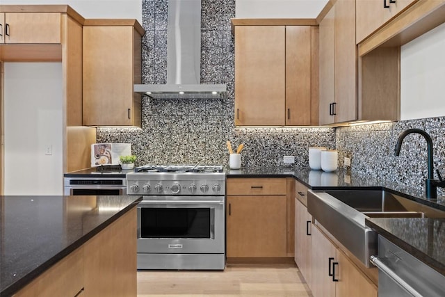 kitchen featuring appliances with stainless steel finishes, tasteful backsplash, dark stone countertops, and wall chimney range hood