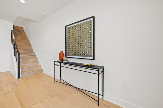 stairs featuring hardwood / wood-style floors