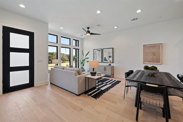 living room featuring light hardwood / wood-style floors and ceiling fan