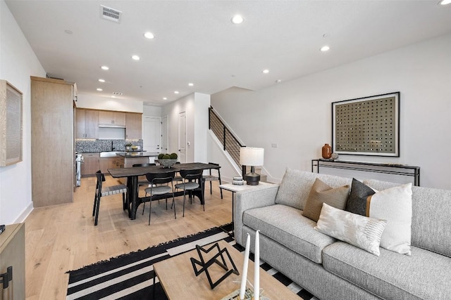 living room with light wood-type flooring and sink