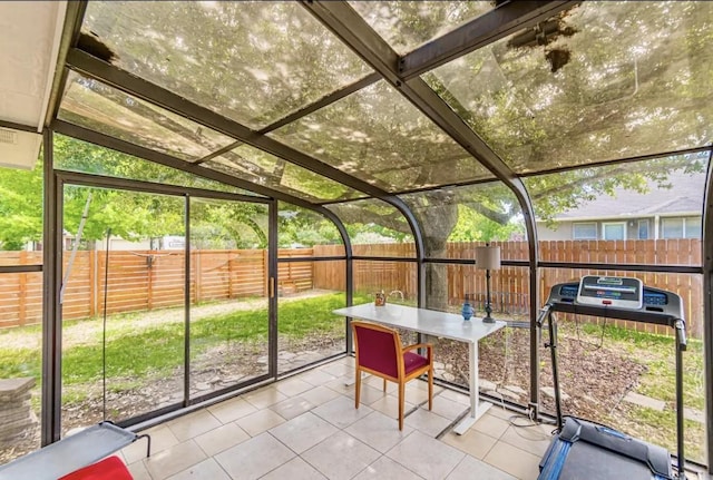 unfurnished sunroom featuring vaulted ceiling