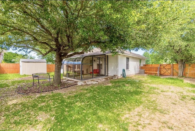 201 Wild Buffalo Dr, Kyle, TX 78640 - view of yard with a sunroom, central air condition unit, and a gate