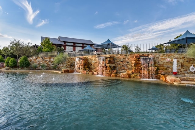 view of swimming pool featuring a water view