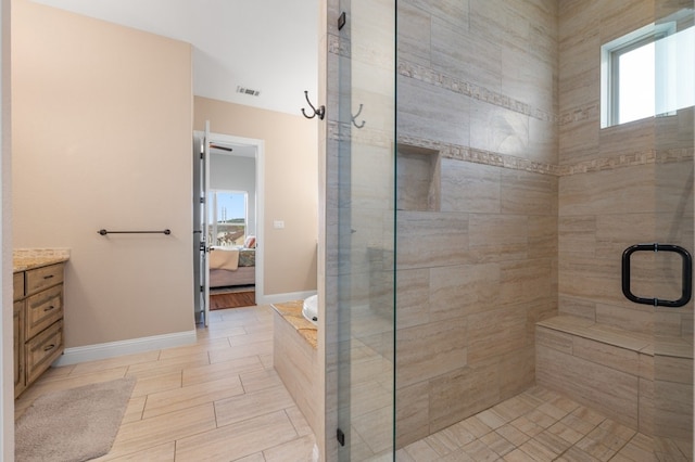 bathroom featuring vanity and an enclosed shower