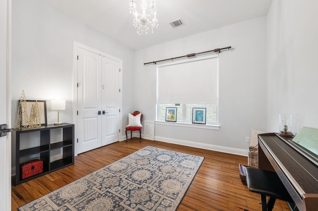 203 Serene Hilltop Cir, Lakeway, TX 78738 - sitting room with wood finished floors, baseboards, and a chandelier