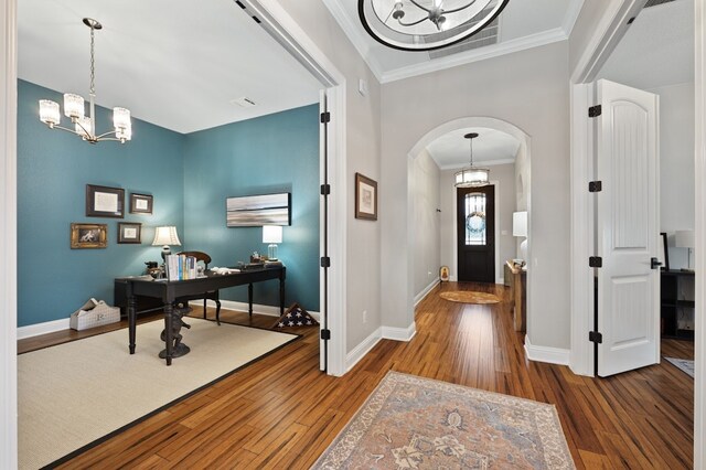 203 Serene Hilltop Cir, Lakeway, TX 78738 - entrance foyer featuring a chandelier, arched walkways, hardwood / wood-style flooring, baseboards, and crown molding