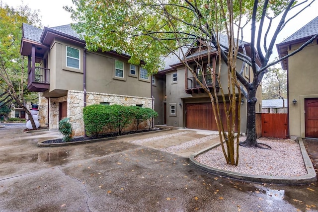 view of front of home with a balcony and a garage