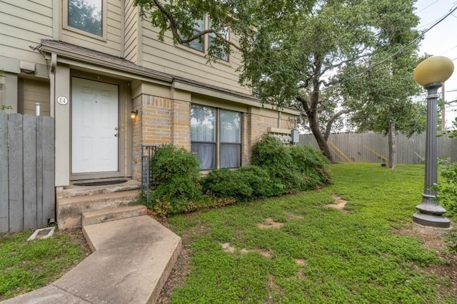 doorway to property with a lawn