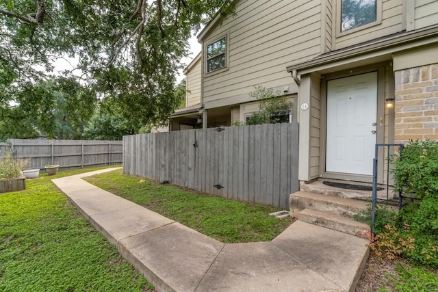 property entrance with a lawn