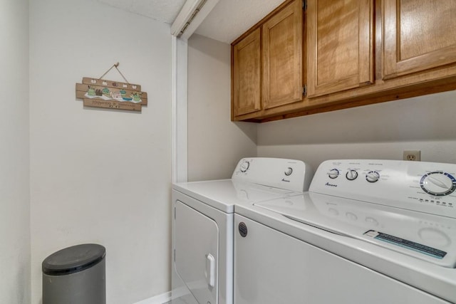 laundry room featuring cabinets and separate washer and dryer