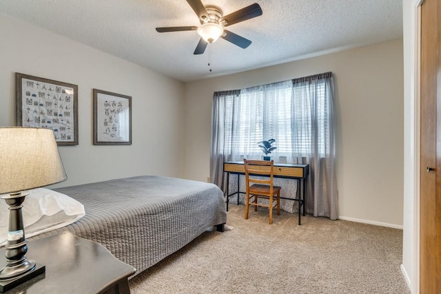 bedroom with light carpet, a textured ceiling, and ceiling fan