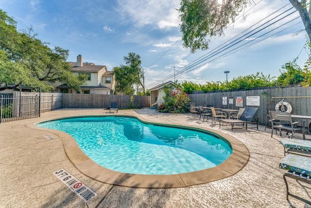 view of swimming pool with a patio area