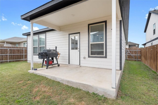 rear view of house featuring a lawn and a patio