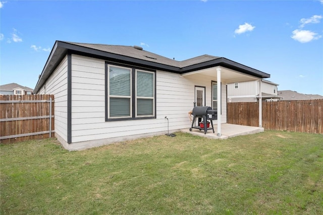 back of property featuring a patio area and a lawn